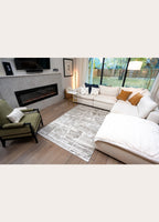 Modern living room with a sectional sofa, armchair, and fireplace.